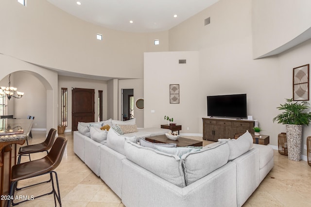 living room with an inviting chandelier and a high ceiling