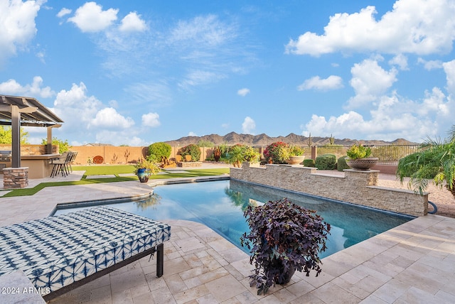 view of pool with a patio area and a mountain view