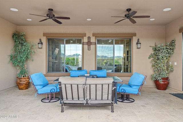 view of patio with ceiling fan and an outdoor living space