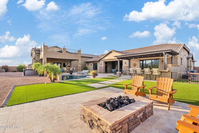 rear view of property with a pool, a yard, and a patio