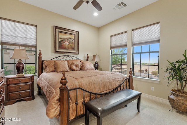 bedroom with ceiling fan and light colored carpet