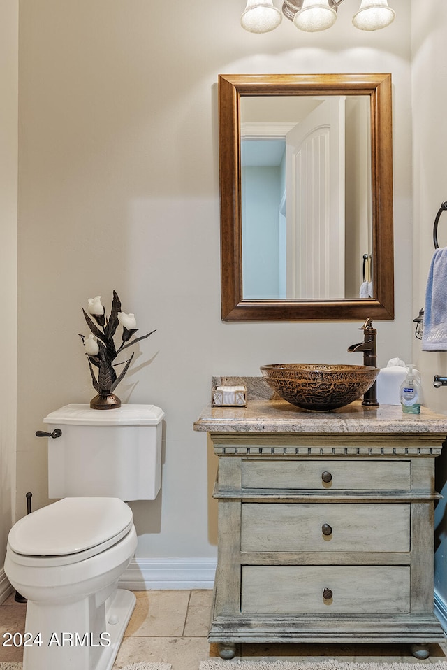 bathroom with vanity, toilet, and tile patterned flooring