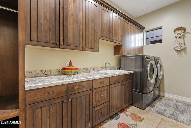 laundry area with cabinets, sink, and washing machine and dryer