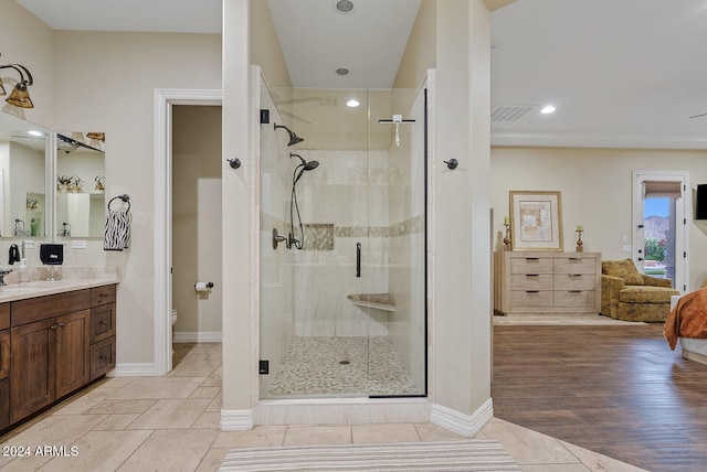 bathroom featuring vanity, hardwood / wood-style floors, toilet, and walk in shower