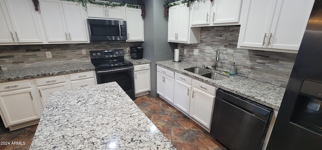 kitchen with white cabinets, sink, tasteful backsplash, and black appliances