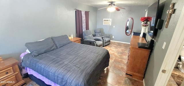 bedroom with an AC wall unit, ceiling fan, and a textured ceiling