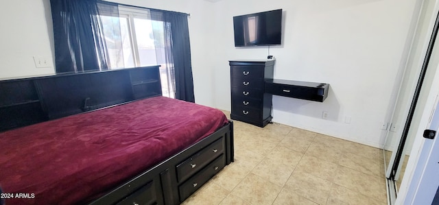 bedroom with light tile patterned floors