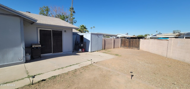 view of yard featuring a patio area and a shed