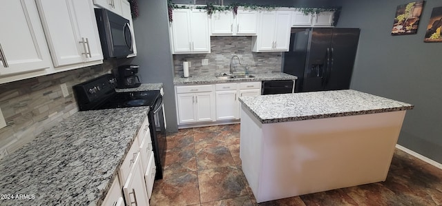 kitchen featuring a center island, backsplash, black appliances, white cabinets, and sink