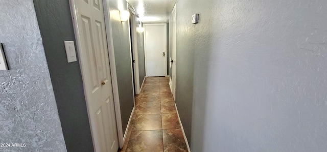 hallway featuring tile patterned flooring