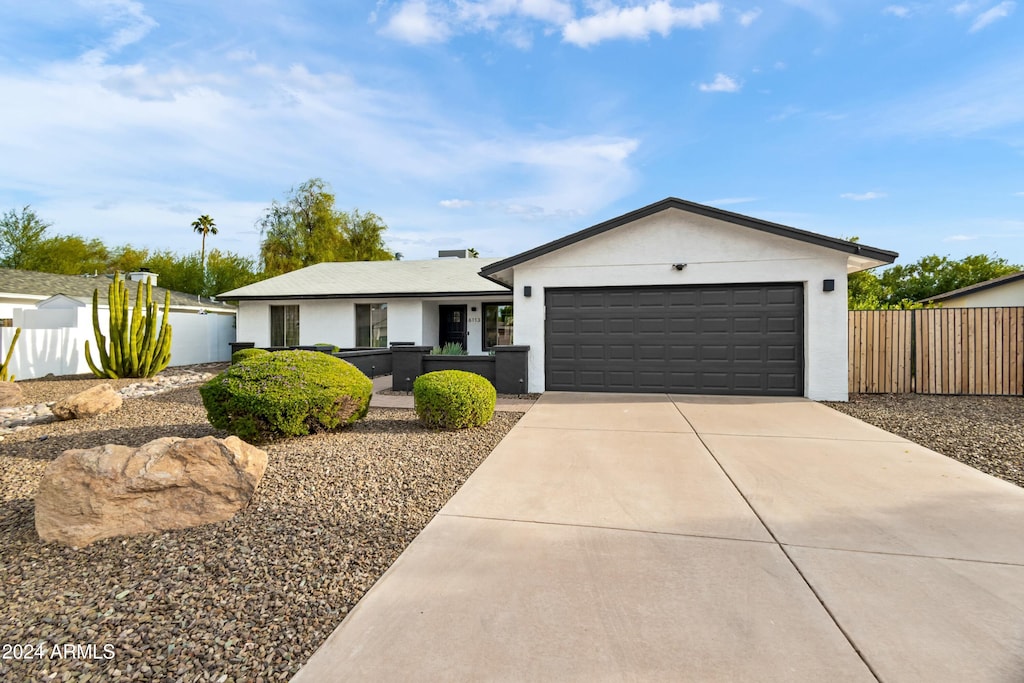 ranch-style home featuring a garage