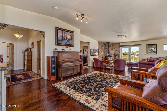 2335 Voyager Cir, Overgaard, AZ 85933 - living room with a wood stove, vaulted ceiling, and dark wood-style floors