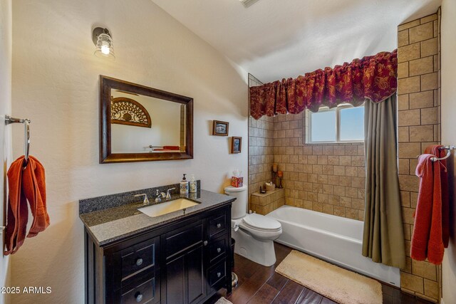 2335 Voyager Cir, Overgaard, AZ 85933 - bathroom featuring wood finished floors, toilet, lofted ceiling, vanity, and shower / bathtub combination with curtain