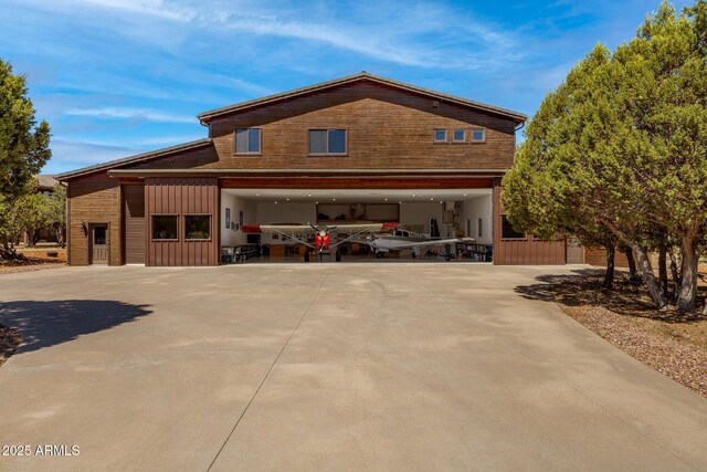 2335 Voyager Cir, Overgaard, AZ 85933 - view of home's exterior featuring a garage, driveway, and board and batten siding