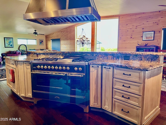 2335 Voyager Cir, Overgaard, AZ 85933 - kitchen with double oven range, extractor fan, open floor plan, dark wood-type flooring, and ceiling fan