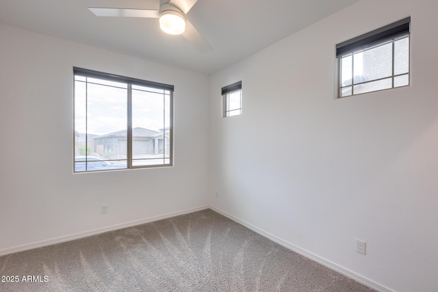 empty room featuring baseboards, carpet floors, and ceiling fan