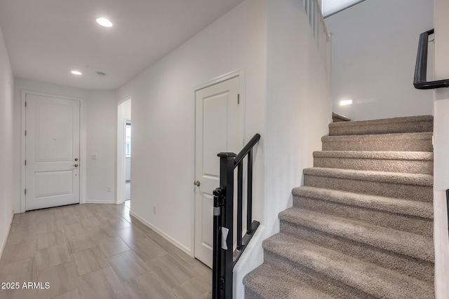 foyer with recessed lighting, stairs, and baseboards