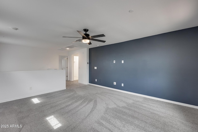 unfurnished room with visible vents, light colored carpet, baseboards, and ceiling fan