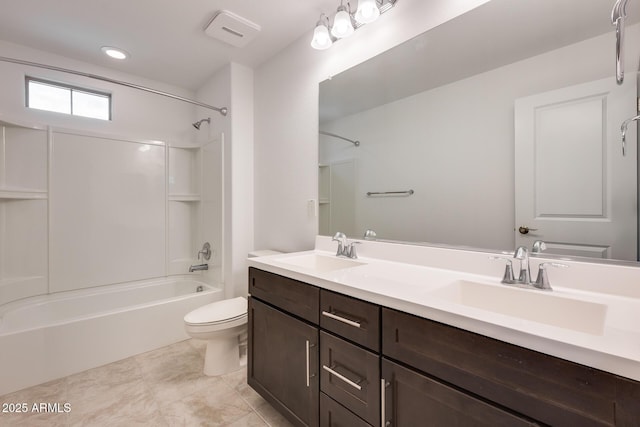 bathroom featuring a sink, toilet, double vanity, and bathing tub / shower combination