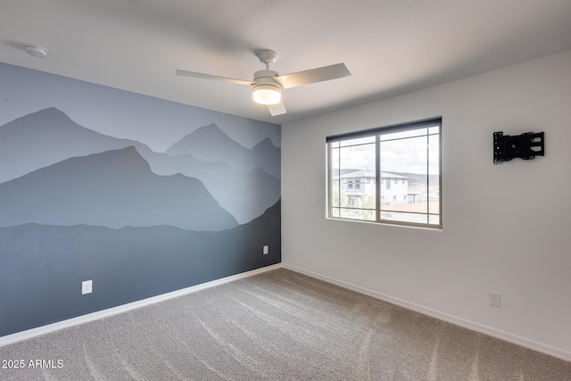 empty room with baseboards, carpet, and a ceiling fan