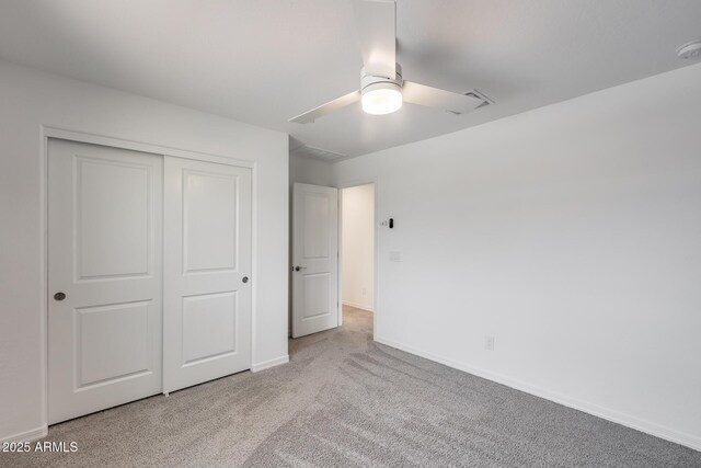 unfurnished bedroom featuring a ceiling fan, carpet flooring, baseboards, and a closet