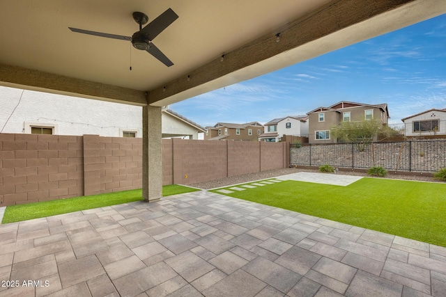 view of patio with a fenced backyard, a residential view, and ceiling fan