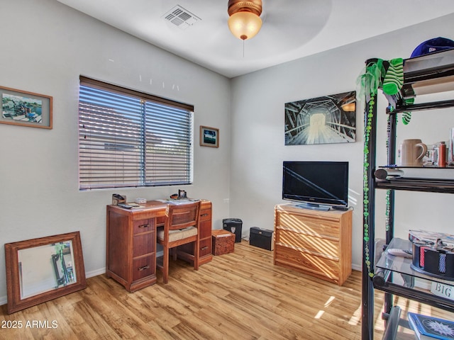 home office featuring baseboards, ceiling fan, visible vents, and wood finished floors