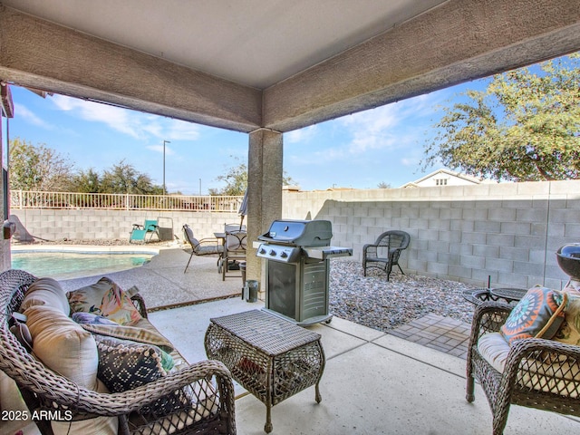 view of patio with a fenced backyard, a grill, and a fenced in pool