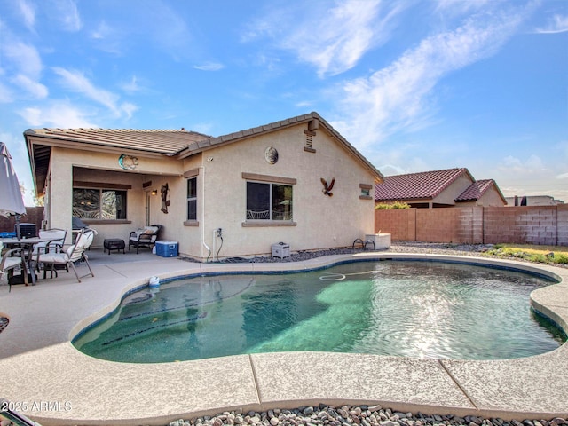 view of swimming pool featuring fence, a fenced in pool, and a patio