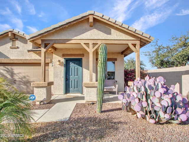 entrance to property with fence and stucco siding