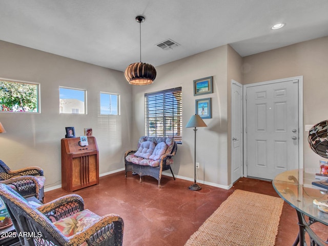 sitting room featuring baseboards, concrete floors, visible vents, and recessed lighting