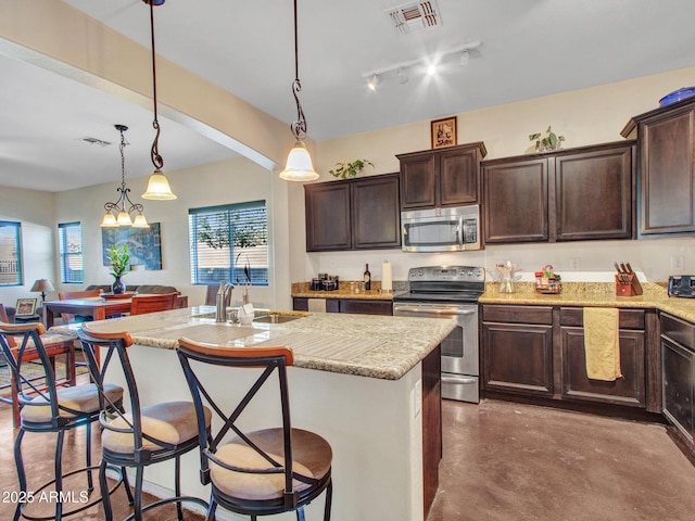 kitchen with dark brown cabinetry, visible vents, and appliances with stainless steel finishes