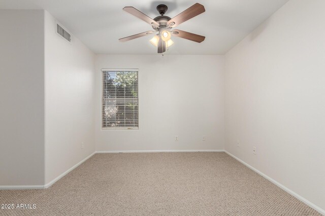 unfurnished room featuring light colored carpet, baseboards, a ceiling fan, and visible vents
