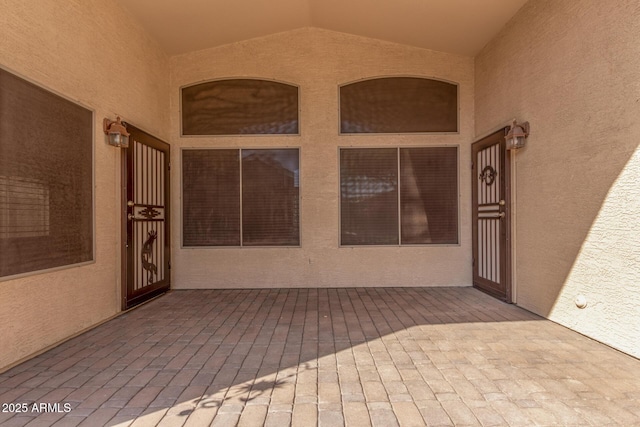 entrance to property featuring stucco siding