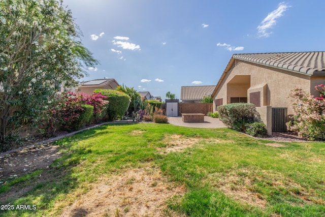 view of yard featuring fence, central AC unit, and a patio
