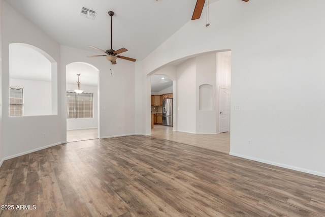 unfurnished living room featuring light wood finished floors, a ceiling fan, and visible vents