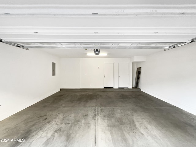 garage with electric panel and a garage door opener