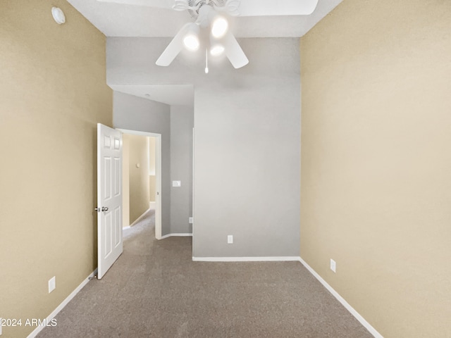 empty room featuring ceiling fan and light colored carpet