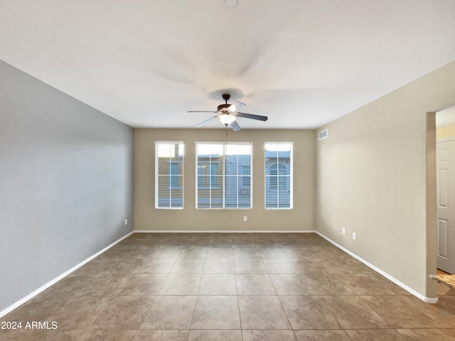 unfurnished room featuring ceiling fan and light tile patterned flooring