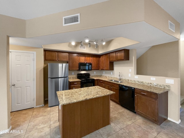 kitchen featuring black appliances, light stone countertops, light tile patterned floors, and sink