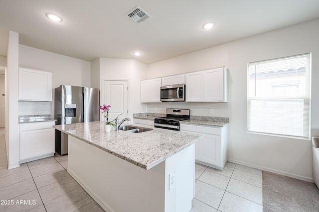 5721 W Coplen Farms Rd, Laveen, AZ 85339 - kitchen featuring stainless steel appliances, a sink, light tile patterned floors, a kitchen island with sink, and recessed lighting