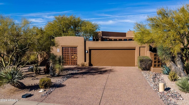 pueblo-style home with a garage