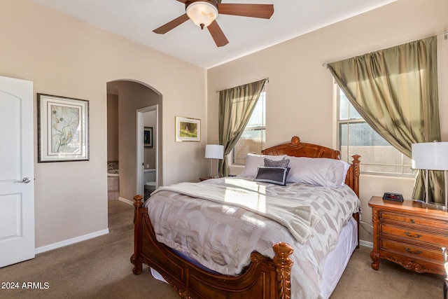 carpeted bedroom with ceiling fan and connected bathroom