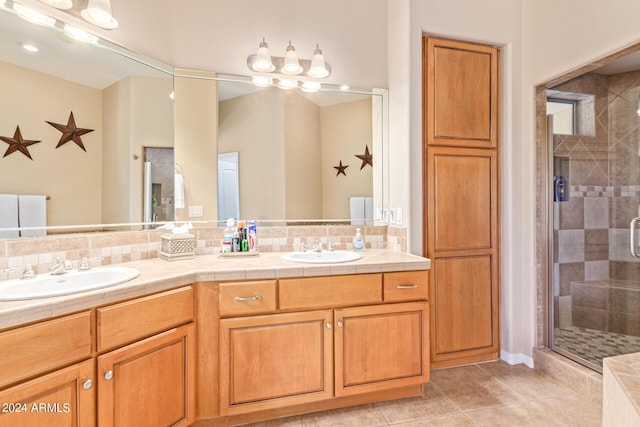 bathroom featuring vanity, tile patterned flooring, and a shower with door