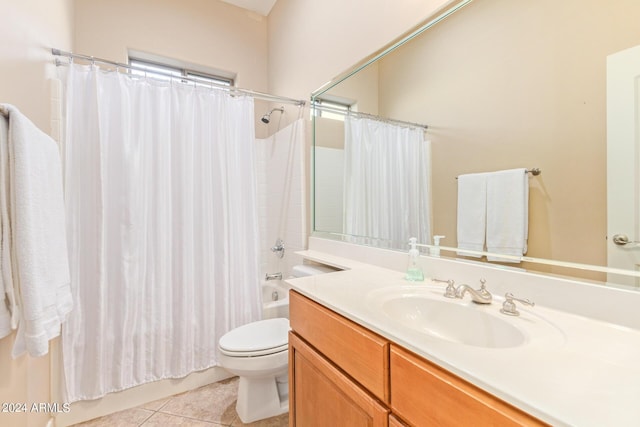 full bathroom featuring vanity, tile patterned floors, toilet, and shower / bath combo