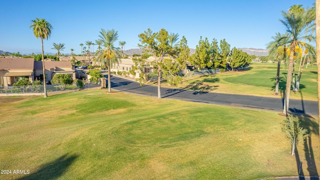 view of property's community featuring a yard and a mountain view