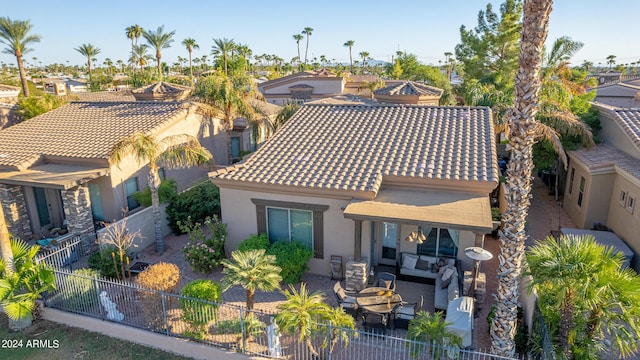 rear view of property with an outdoor hangout area and a patio