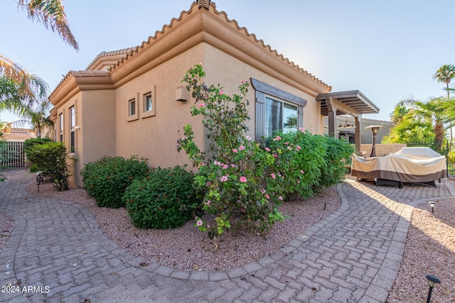 view of property exterior with a patio area