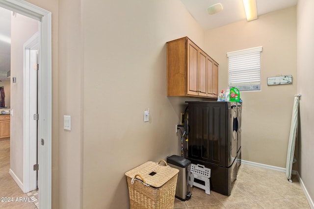 washroom featuring cabinets, light tile patterned floors, and independent washer and dryer