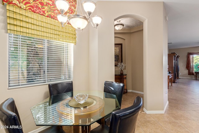 dining room with light tile patterned floors, a wealth of natural light, and a chandelier